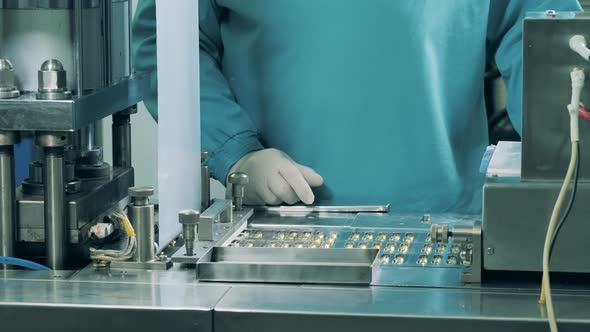 A Worker Checks Capsules Moving on a Line at Laboratory. Pharmacy Industry, Medical Factory