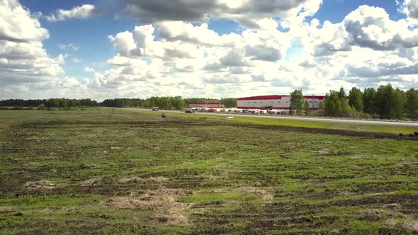 Aerial Motion Above Field Covered with Green and Dry Grass