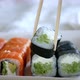 Wooden Sticks Take the Maki Roll and Dip It Into the Soy Sauce - VideoHive Item for Sale