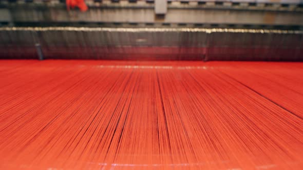 Red Threads are Being Used By a Factory Mechanism for Weaving