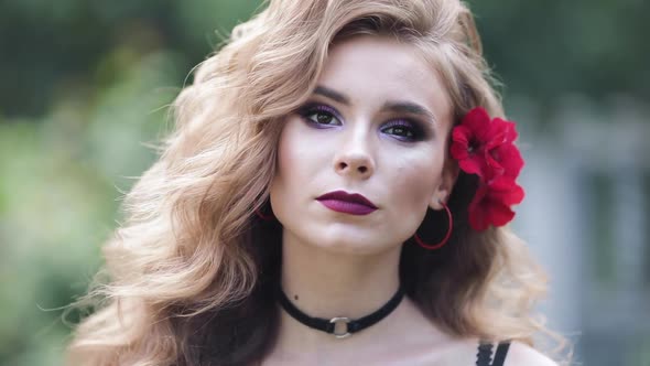 Young Blonde Girl with Curly Hair Looking Forward Seriously