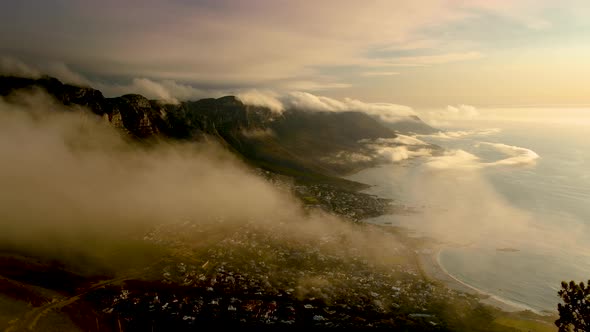 Strange low cloud formations over mountains, Camps Bay in view, Cape Town South Africa