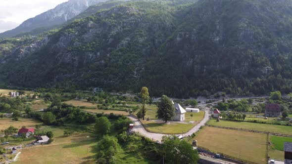 Flying Near Old Wooden Church and Trees in Thethi Valley Albania