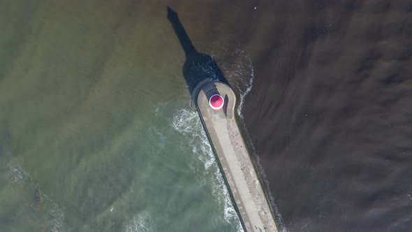 A Lighthouse and Breakwater at the Mouth of a Harbour in the UK