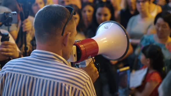 Political Rally Campaign with Bullhorns and Megaphones on Peaceful City Streets