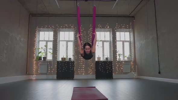 Aerial Yoga  a Young Woman Leans Her Body on a Hammock and Swings