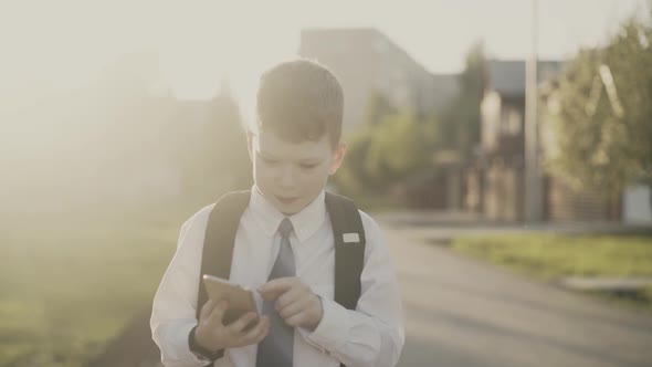 CU, Tracking: Portrait of Schoolboy Boy, with Knapsack Behind His Back, in School Uniform