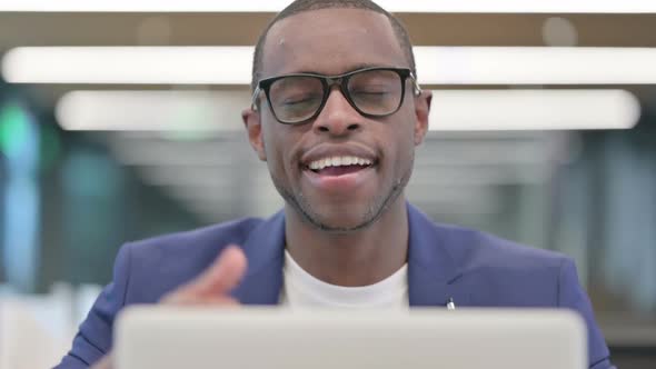 Thumbs Up By African Businessman with Laptop at Work