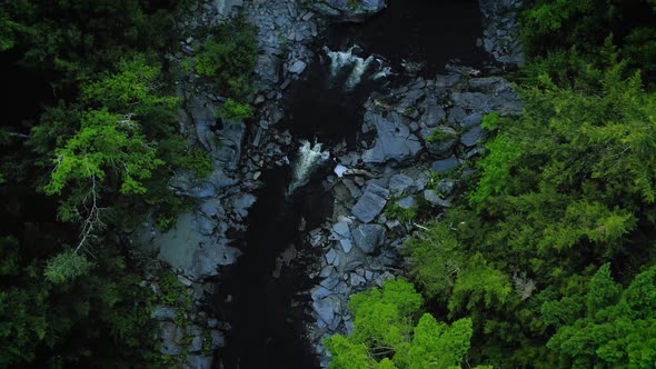 Aerial shot over Piscataquis River at Barrel Falls.