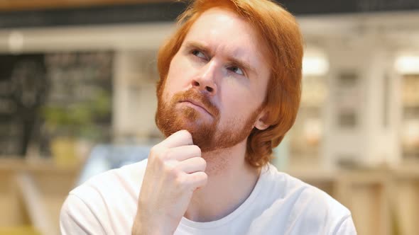 Portrait of Thinking Redhead Beard Man in Cafe, Brainstorming