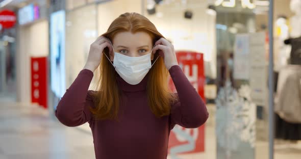 Young Woman Wearing Protection Face Mask Against Coronavirus Shopping in Mall