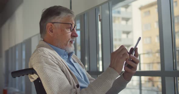 Caucasian Aged Male Patient Using Mobile Phone at Retirement Home