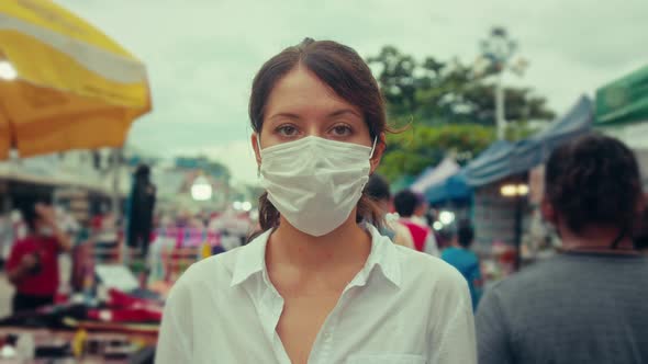 Portrait of a Young Tourist Woman Wearing Protective Mask on Street Crowd People