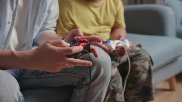 Close Up Of Hand's Father And Son Using Joystick Play Game