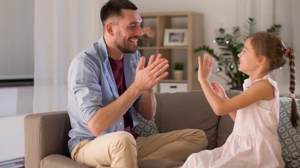 Father and Daughter Playing Clapping Game at Home 7