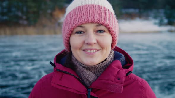 a Woman in Winter Clothes Looking at the Camera and Smiling