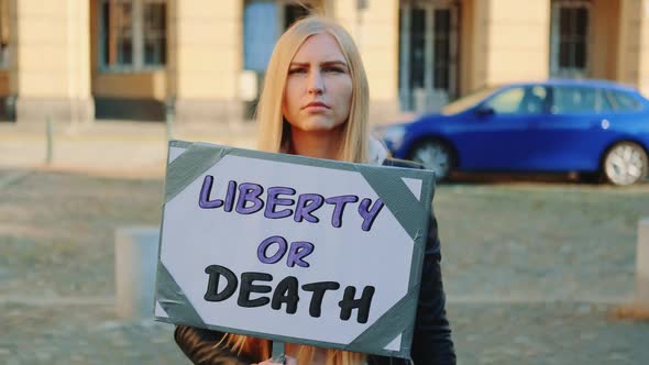 Blonde Woman with Protest Banner Calling To Choose Liberty or Death