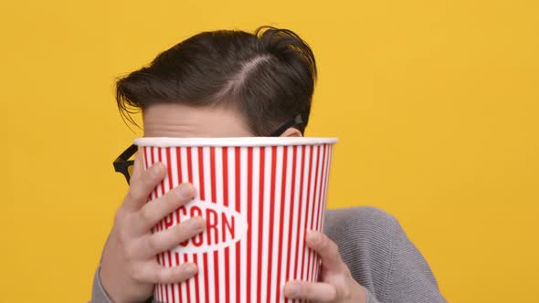 Boy Watching Horror Movie Hiding Behind Popcorn Bucket Yellow Background