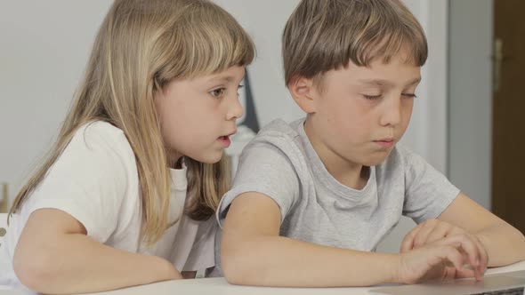 Brother Helps His Younger Sister to Make Her Homework