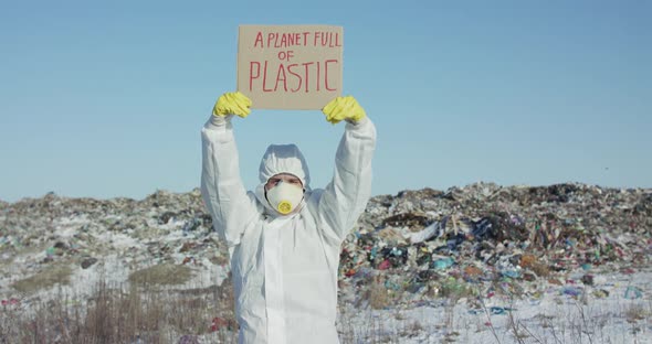 Man Shows Protest Sign a Planet Full of Plastic Against Plastic Landfill