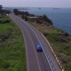 Blue Car Driving along Coastal Road - VideoHive Item for Sale