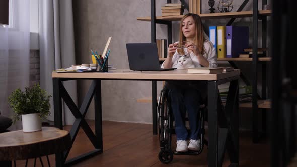 Tired Handicapped Female Working on Laptop at Home