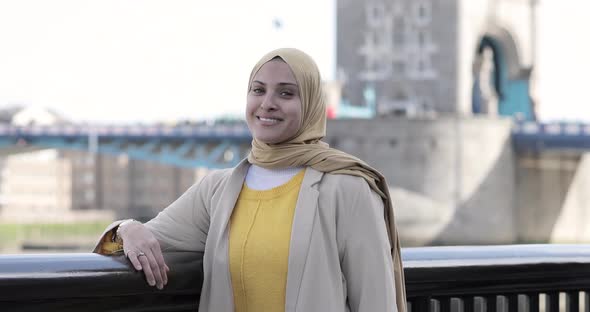 Smiling woman wearing hijab in the city, London, England