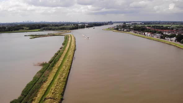 High Aerial View Of River Noord With Inland Cargo Ship Travelling Along. Dolly Forward, Establishing