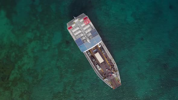 Aerial view above ferry boat with cars in the mediterranean sea, Kosta, Greece.