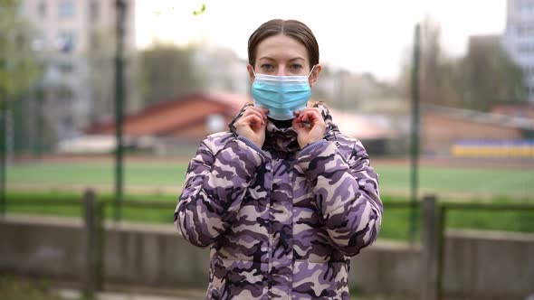 Young Mom Puts on and Takes Off Medical Mask. The Beginning and the End of Pandemic. Close Up