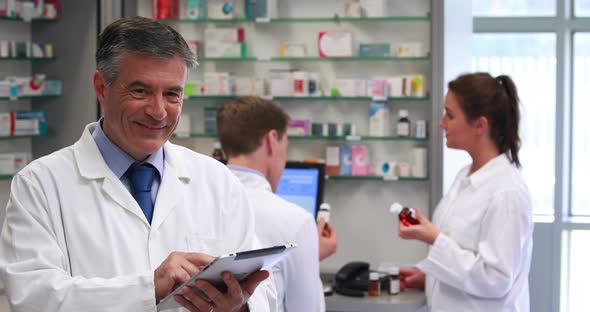 Senior Pharmacist Using Tablet PC