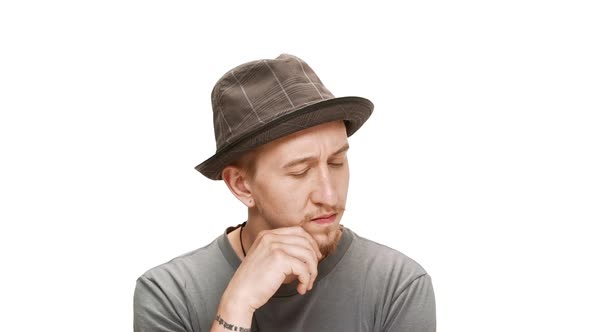 Young Handsome Man in Hat Thinking Considering Smiling Over White Background