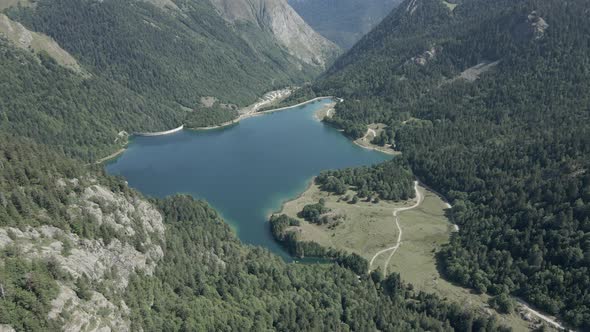 Beautiful Aerial View Forwarding Shot Over Lake Ayous with Green Forest on All Sides on a