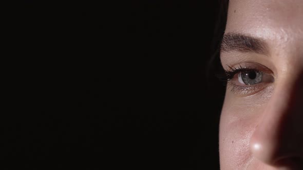 Macro Portrait of Beautiful Young Woman 20s Having Blue Eyes Blinking and Looking Aside Isolated