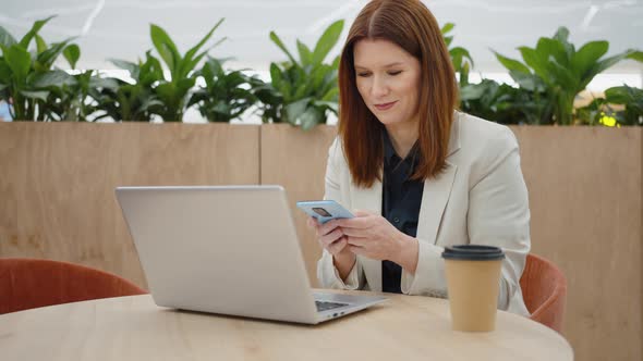 Businesswoman Smiling While Texting Message on Phone