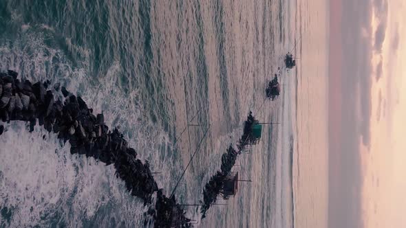 Vertical video of cliff in the ocean at sunset