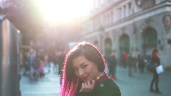 Sexy Stylish Woman Looking at Camera and Smiling in the Middle of a Crowded Summer Street. Cute Girl