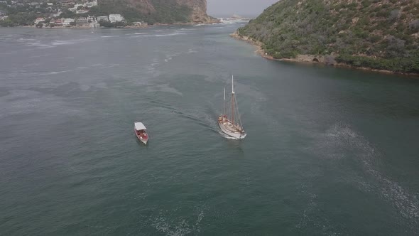 Aerial: Sailing ship and tour boat in Knysna Harbour lagoon