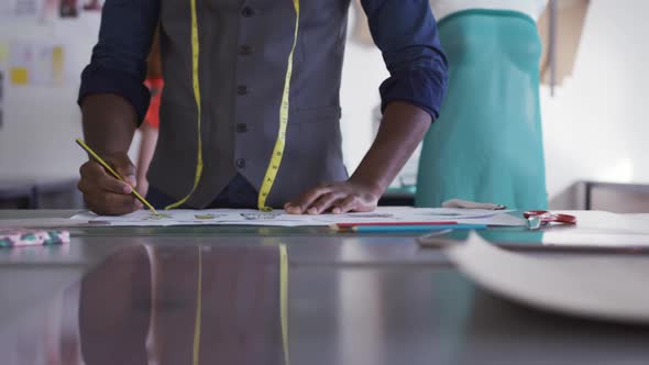 Mixed race man working in fashion office