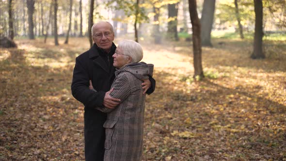 Happy Old Couple Dancing in Autumn Park