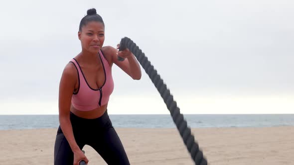 Mixed ethnicity woman exercising at the beach