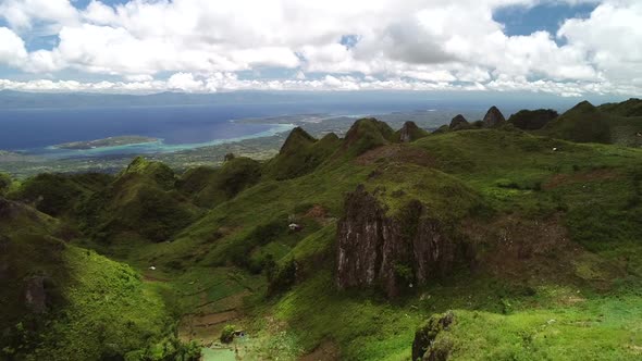 Aerial view of peak Chocolate hills and cloudy sky in Badian, Philippines.