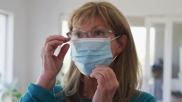 Senior woman wearing face mask at home