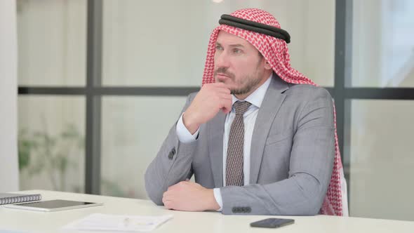 Pensive Middle Aged Arab Businessman Thinking While Sitting in Office