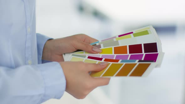 Close Up Shot of Unrecognizable Woman Designer Choosing Color for Project Hands Mixing Color