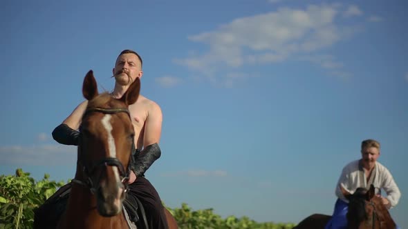 Ukrainian Cossack Riding a Horse in the Field Looks Far