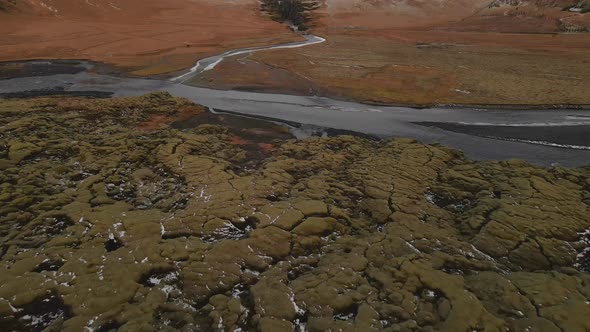 Aerial Shot of Mossy Lands and a Stream of Water