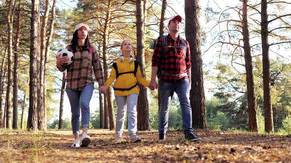Happy Family Hiking Through a Forest