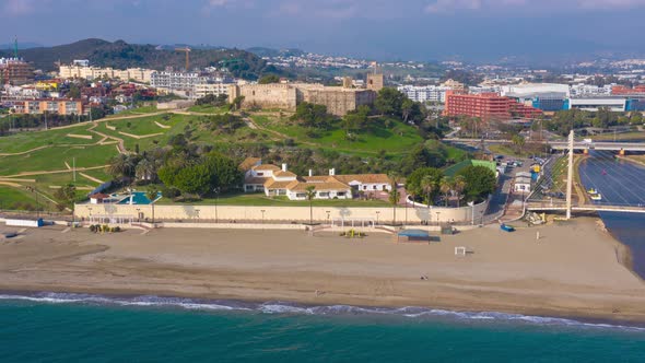 Aerial drone hyperlapse timelapse of Fuengirola Sohail Castle on the beachfront in Spain in winter alt
