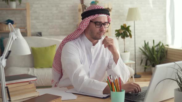 Arab Man Businessman at Work at a Laptop